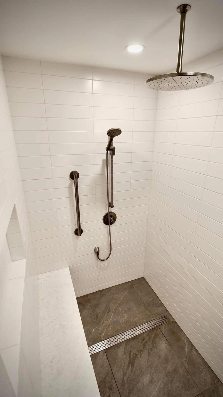 Roll-in shower with a ceiling rain head, a hand-held shower on a vertical slide bar, a grab bar and a linear drain, Mesa, AZ