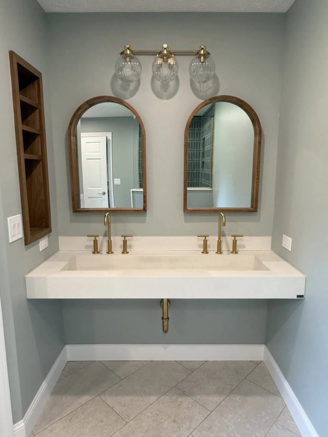Wall-hung trough sink with open knee clearance underneath and lever-handle faucets, accessible bathroom remodeling in Mesa, AZ